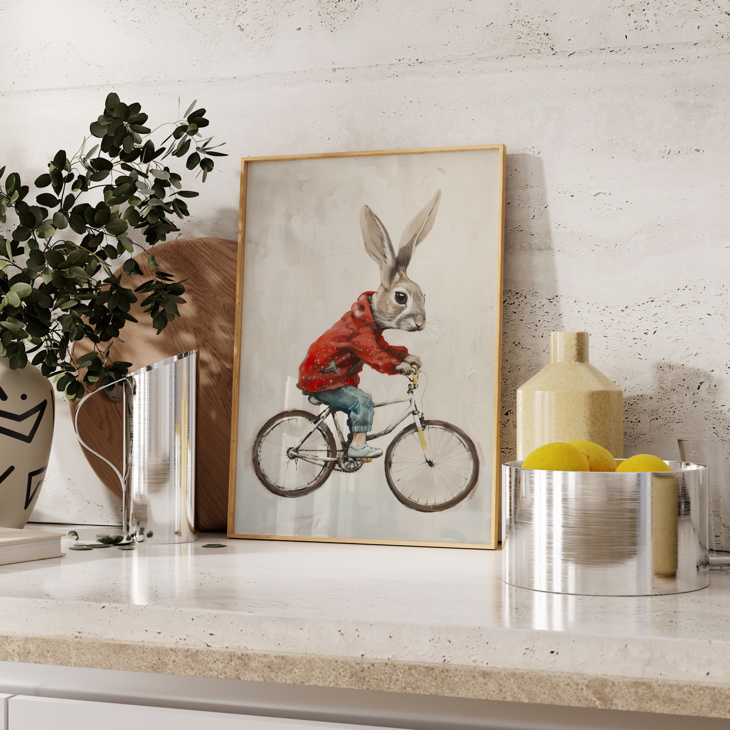 a rabbit riding a bicycle, wearing a red jacket and jeans, in Paw Prints framed poster leaning against the kitchen counter.